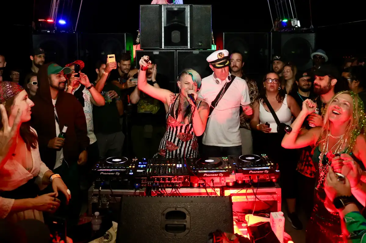 DJs with group dancing on a boat