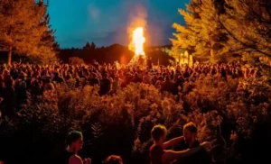 A giant bonfire surrounded by a thousand people