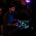 House music DJ with deck lit red