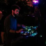 House music DJ with deck lit red