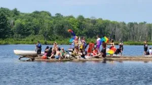 A group on a rock by a river