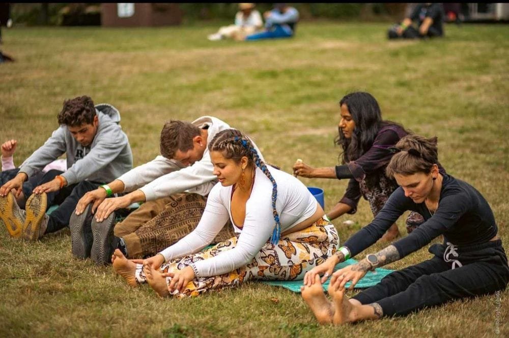 People stretching with sound bowl being rung