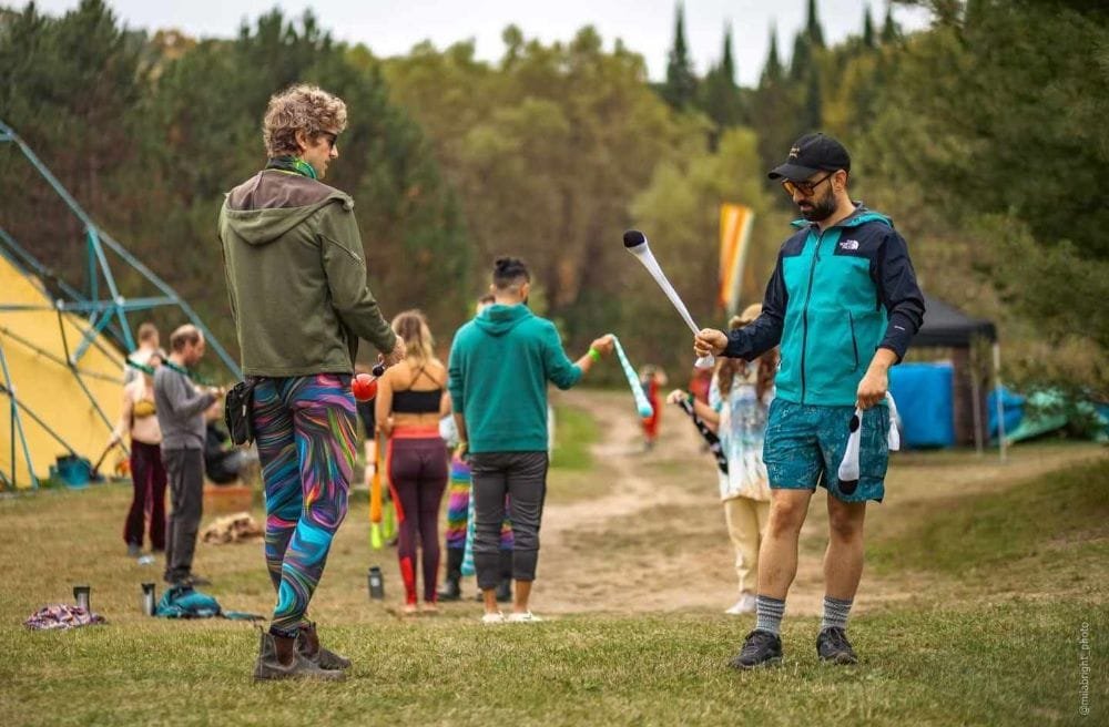 Men spinning poi balls
