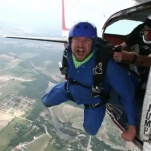 Andre jumping out of plane with a parachute