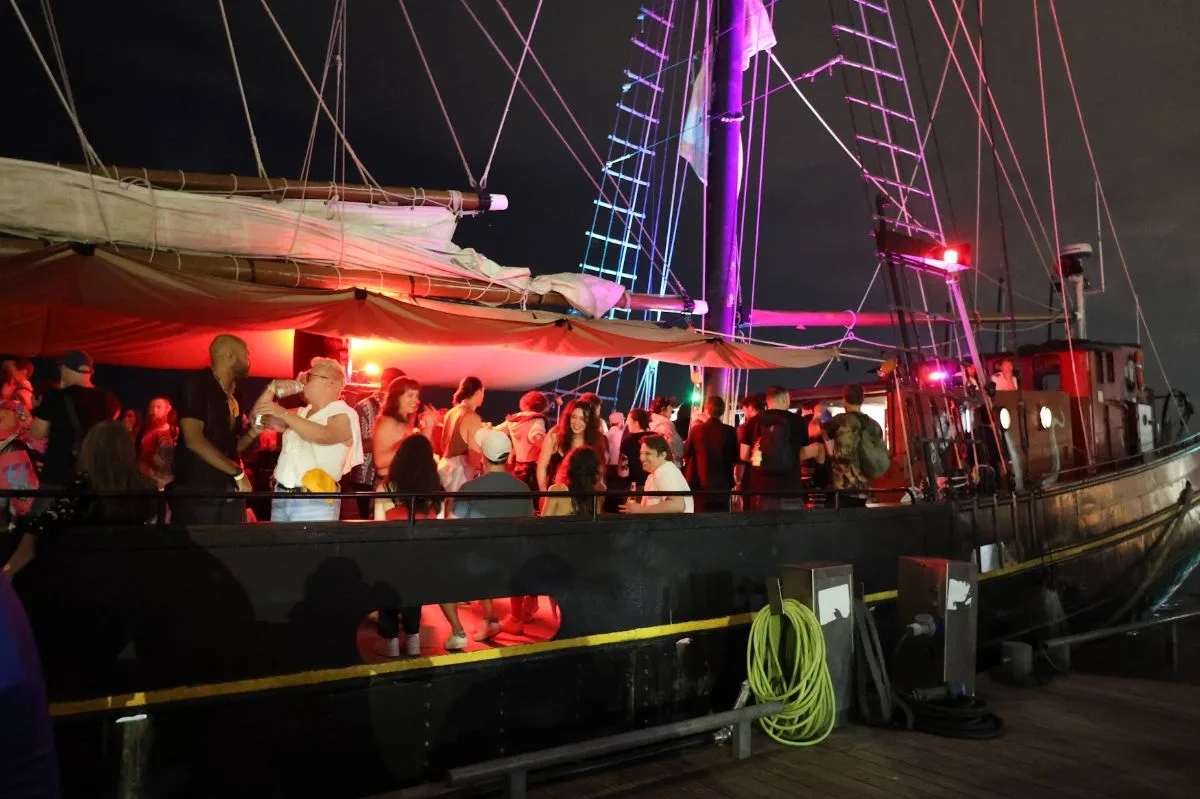 The tall ship Kajama at dock. People on board.