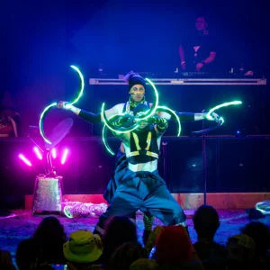 Performer with glowing light props.