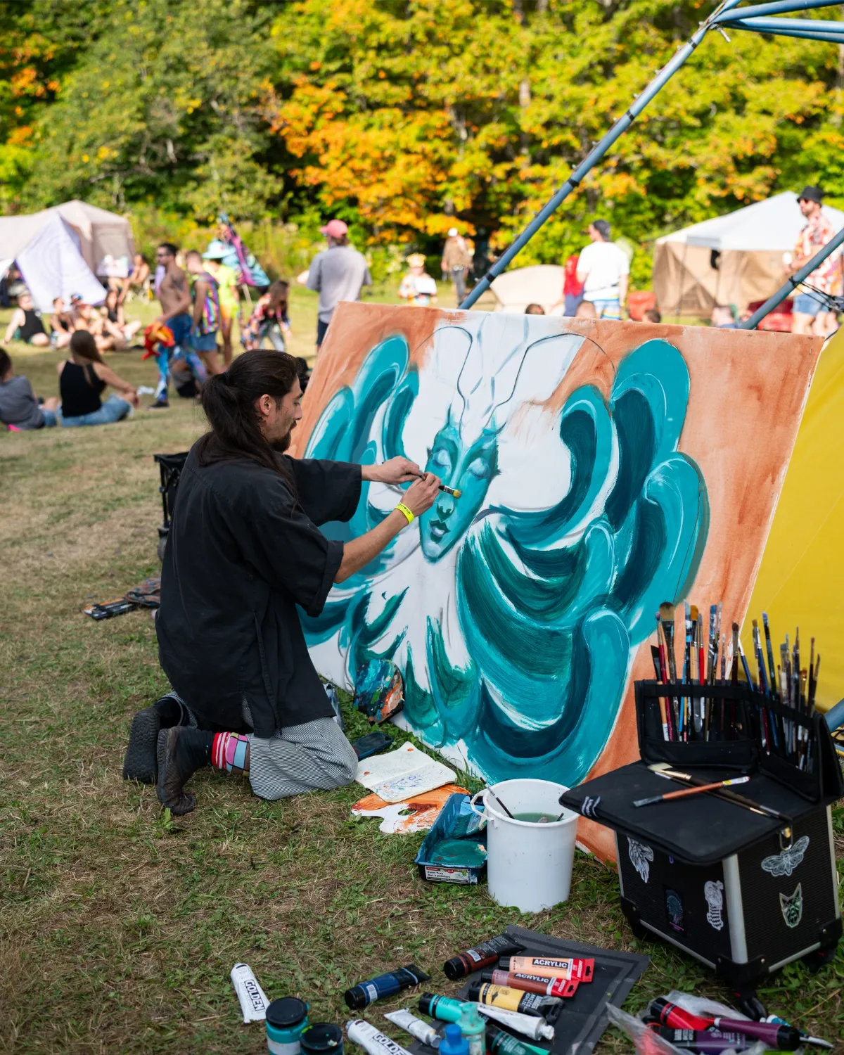 Painter outside with mural
