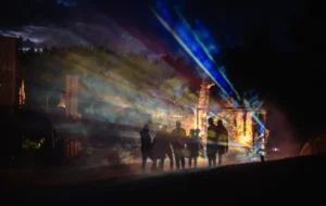 Silhouettes against colorful light beams