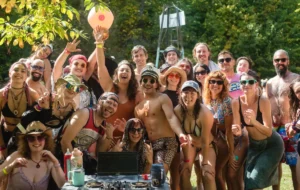 A group of people in bathing suits behind a laptop