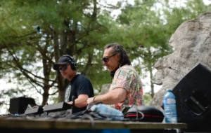 Two DJs (Greg Gow and TAKiN) performing amongst trees