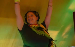 DJ with hands up in the air, smiling