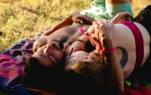 A couple cuddling on a blanket