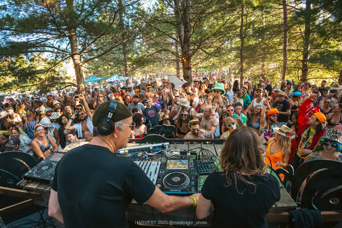 Behind DJs at day party outside