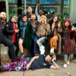 A group with one person lying on the sidewalk in front