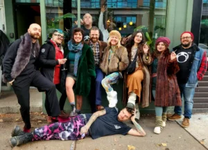 A group with one person lying on the sidewalk in front