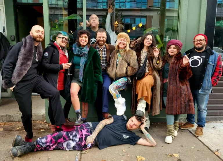 A group with one person lying on the sidewalk in front