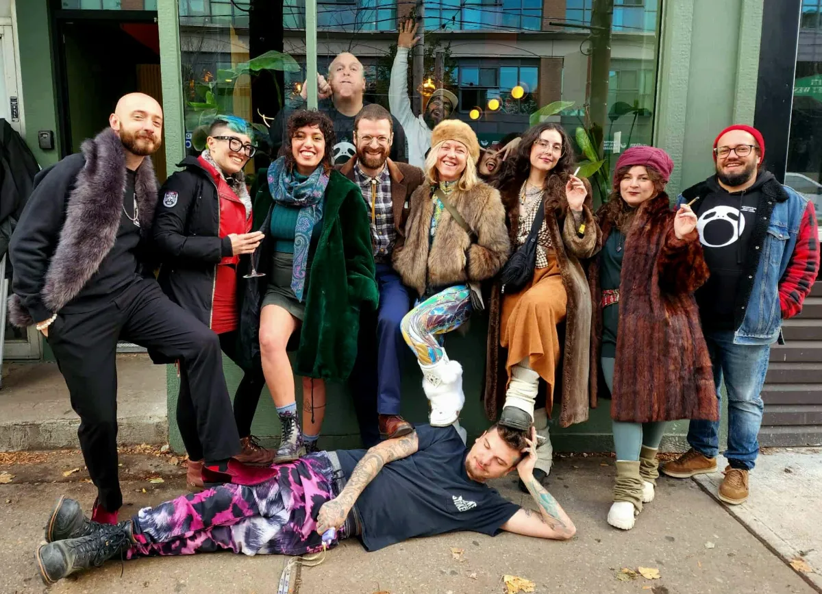 A group with one person lying on the sidewalk in front