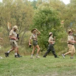 A line of park rangers walking by