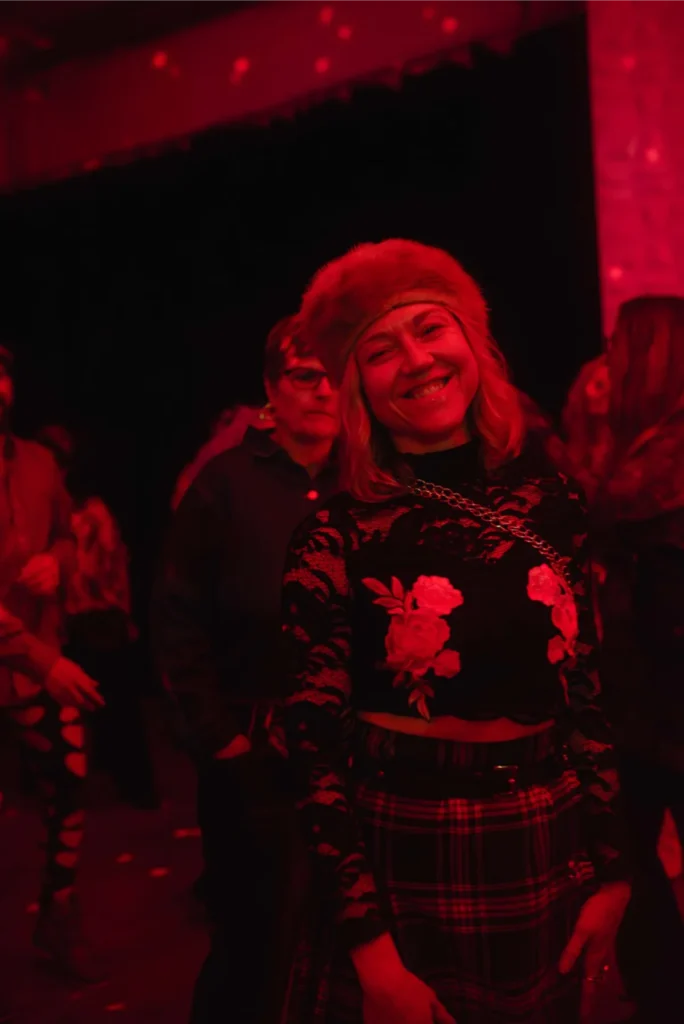 Woman smiling lit red