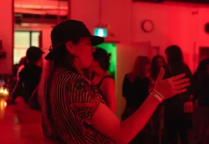 Woman with a hand up lit red