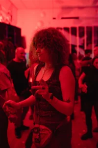 Woman with fizzy hair lit red