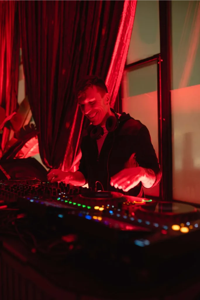 DJ smiling lit red