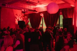 A Sunday Afternoon Social with a red lit dancing crowd