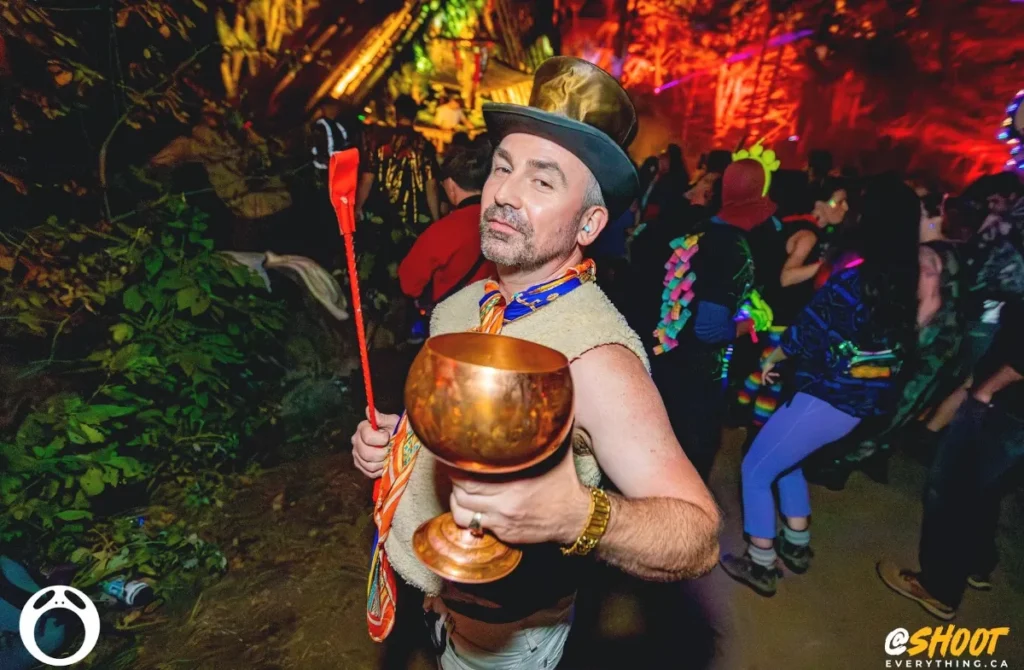 Man with top hat holding a chalice cup up and wip