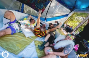 Plounge group laughing with a man man with legs in the air