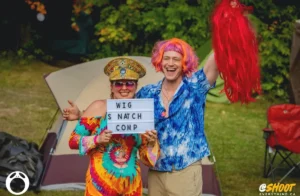 Couple with Wig Snatch Comp sign
