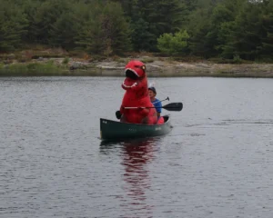 Dino costume in canoe