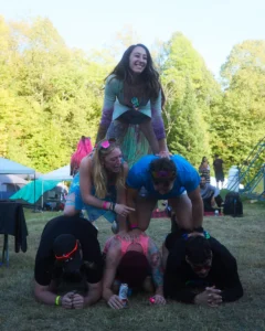 A group sitting on each other in a pyramid shape