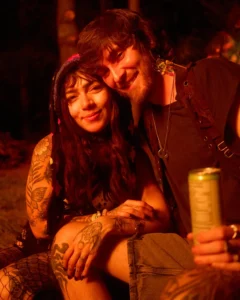 Couple smiling by firelight