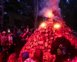 Masive cone of logs being lit