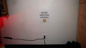 Please don't kick the wall sign