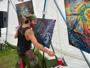A man painting with paintings