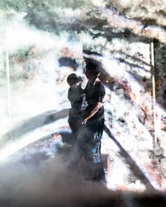 A couple in mist lit from behind