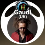 Studio photo of man with dreadlocks, sunglasses, and red jacket