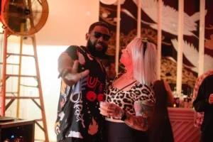 Man in graphic tee and woman in leopard print top at a party
